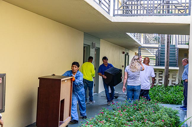 Volunteers carry some of the furniture