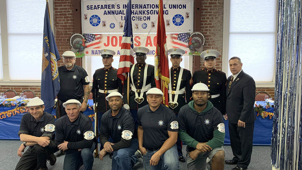Group photo of Seafarers and Marine Corps Color Guard