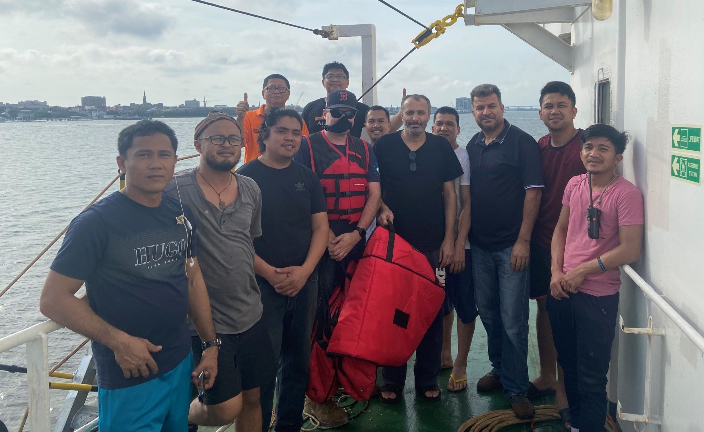 Grateful crew members are pictured with ITF Inspector Corey Connor (wearing face covering).