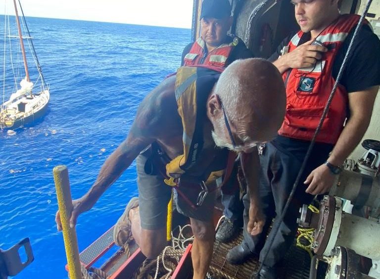 Photo of person who was rescued, climbing aboard ship