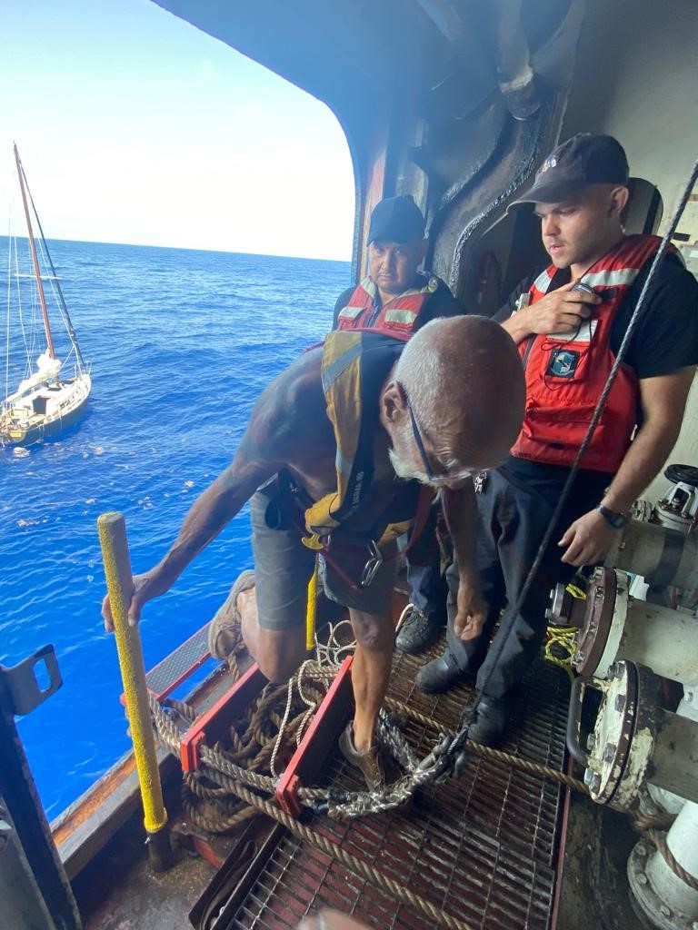 Photo of person who was rescued, climbing aboard ship