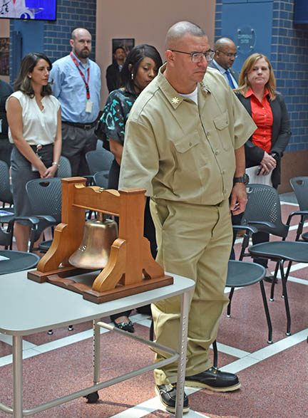 Photo of apprentice ringing bell during ceremony